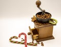 Hand grinder and Christmas candy on light background Royalty Free Stock Photo