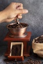 Hand grinding coffee beans in wooden grinder Royalty Free Stock Photo