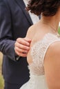 The hand of the groom on the back of the bride. soft touch