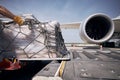 Loading of cargo containers to plane at airport Royalty Free Stock Photo