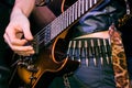 Hand of a guitarist plays live music on his electrical solo guitar, cool hard rock