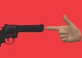 A hand gun gesture and a revolver pointing at each other Royalty Free Stock Photo