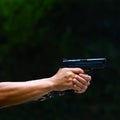 Hand gun pistole in a man hand