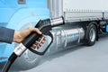 Hand with H2 fueling nozzle on a background of hydrogen fuel cell semi truck with Royalty Free Stock Photo