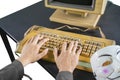 Hand of hacker typing on keyboard with clown mask