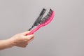 Hand with hair comb and hair brush, hair loss concept Royalty Free Stock Photo