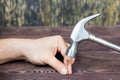 A hand with a hammer clogs a nail Royalty Free Stock Photo