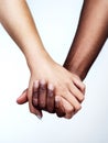 Hand in hand through it all. Studio shot of two unrecognizable people holding hands against a grey background. Royalty Free Stock Photo