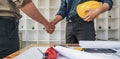 Hand in hand between project contractors and customers due to negotiation of expenses and investments, construction and Royalty Free Stock Photo