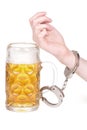 Hand handcuffed to a beer mug