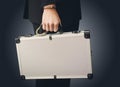 Hand in handcuffs holding money suitcase Royalty Free Stock Photo