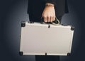 Hand in handcuffs holding money suitcase Royalty Free Stock Photo