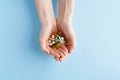 Hand with handful of scattered medicines, pills and tablets on blue background Royalty Free Stock Photo