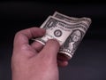 Hand handing over money in hand. US dollar USD bills. Concept of giving Royalty Free Stock Photo