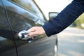 Hand on handle. Close-up of female hand opening a car door Royalty Free Stock Photo