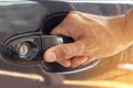 Hand on handle Close up of man hand opening car door Royalty Free Stock Photo