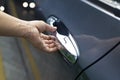 Hand on handle, man opening a car door on the street Royalty Free Stock Photo