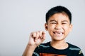 A little boy holds a fallen baby tooth signifying oral hygiene. First tooth lost Royalty Free Stock Photo