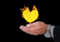 hand with heart fire icon over. Black background Royalty Free Stock Photo