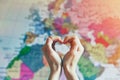 hand in heart shape with love on world map Royalty Free Stock Photo