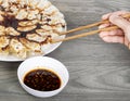 Hand held chopsticks reaching for Dumplings