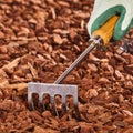 Hand held garden rake over wood chips