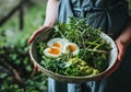 hand held image of someone holding a bowl of greens, eggs