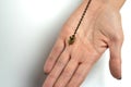 Hand-held pendulum over the arm of a dowser. Royalty Free Stock Photo