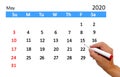 Hand highlighting date on calendar Royalty Free Stock Photo