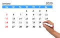 Hand highlighting date on calendar Royalty Free Stock Photo