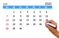 Hand highlighting date on calendar Royalty Free Stock Photo