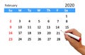 Hand highlighting date on calendar Royalty Free Stock Photo