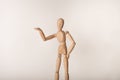 Hand on hip arm in the air presenting wooden jointed manikin