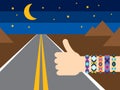 Hand with hippy friendship bracelets hitchhiking