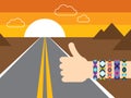Hand with hippy friendship bracelets hitchhiking