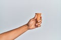 Hand of hispanic man holding biscuit cone over isolated white background Royalty Free Stock Photo