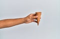 Hand of hispanic man holding biscuit cone over isolated white background Royalty Free Stock Photo