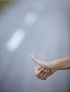 Hand hitchhike on empty road travel adventure Royalty Free Stock Photo
