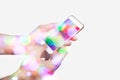 Hand hoding smart phone with bokeh. Royalty Free Stock Photo