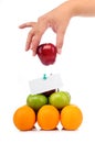 A hand hold an apple on fruit pyramid Royalty Free Stock Photo