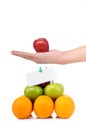 A hand hold an apple on fruit pyramid Royalty Free Stock Photo