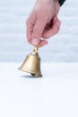 Hand hold bell golden white background copy space school teather manager