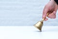 Hand hold bell golden white background copy space school teather manager