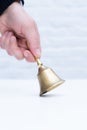 Hand hold bell golden white background copy space school teather manager