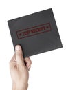 Hand hold black document envelope stamped top secret icon isolated on white background with clipping path Royalty Free Stock Photo