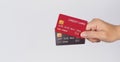 Hand is hold black and red credit card on white background Royalty Free Stock Photo