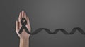 Hand hold black ribbon on background. Mourning is the grieving process. Melanoma and Skin Cancer Awareness Calligraphy Poster