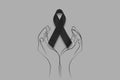 Hand hold black ribbon on background. Mourning is the grieving process. Melanoma and skin cancer, Vaccine injury awareness month