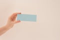 Hand hold blank business card. Mockup of female hands holding blank paper list isolated at white background with shadow Royalty Free Stock Photo