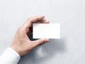 Hand hold blank plain white business card design mockup. Royalty Free Stock Photo